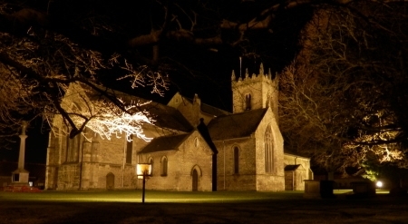 Floodlit church and memorial from NE